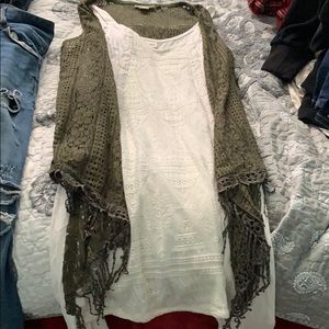 white dress with a green cardigan (sleeveless)